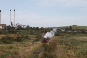 Leader departs Kemsley Down, the paper mill can be seen on the left